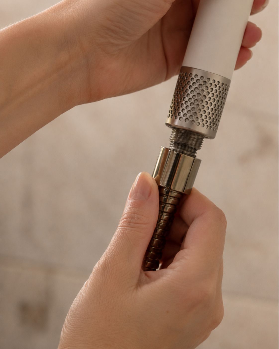 Hands screwing the Lavero shower head onto the shower arm — no tools required